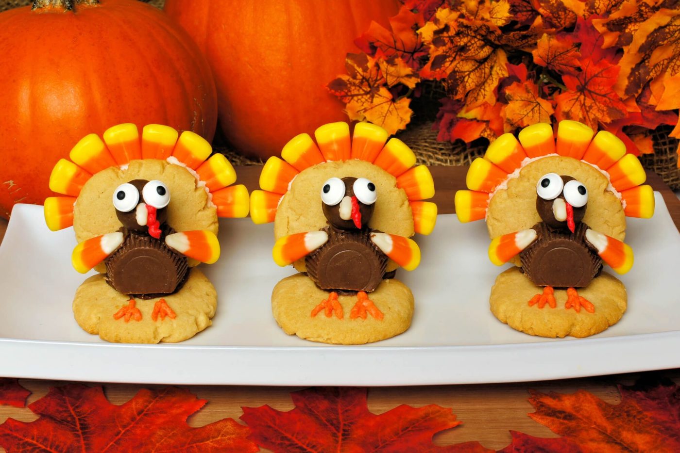 Cookies with thanksgiving turkeys made out of candy on them.